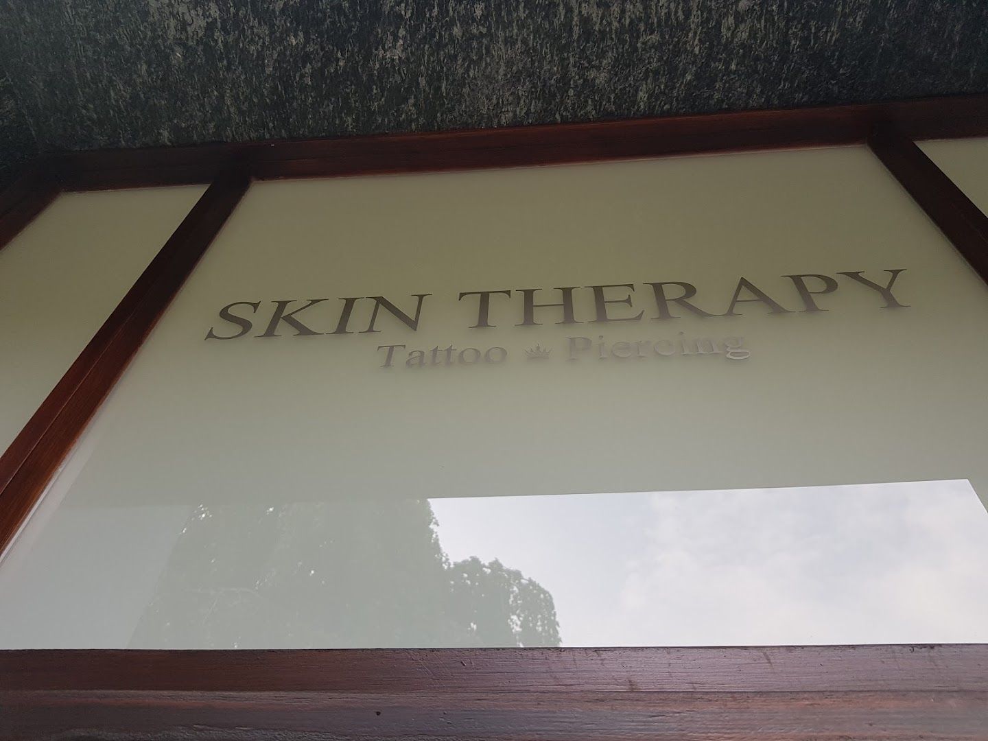 the sign for skin therapy in the window