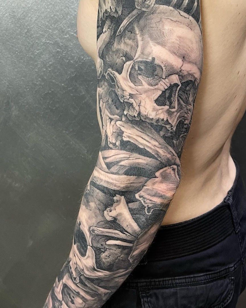 a man with a skull and a cigarette narben tattoo on his arm, bonn, germany