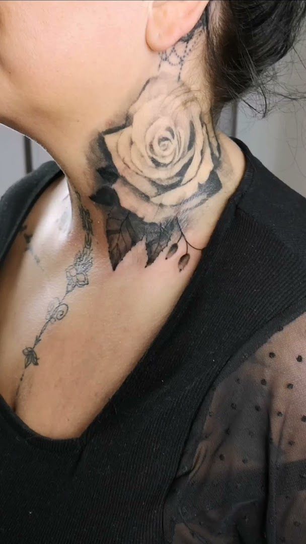 a woman with a rose narben tattoo on her neck, barnim, germany