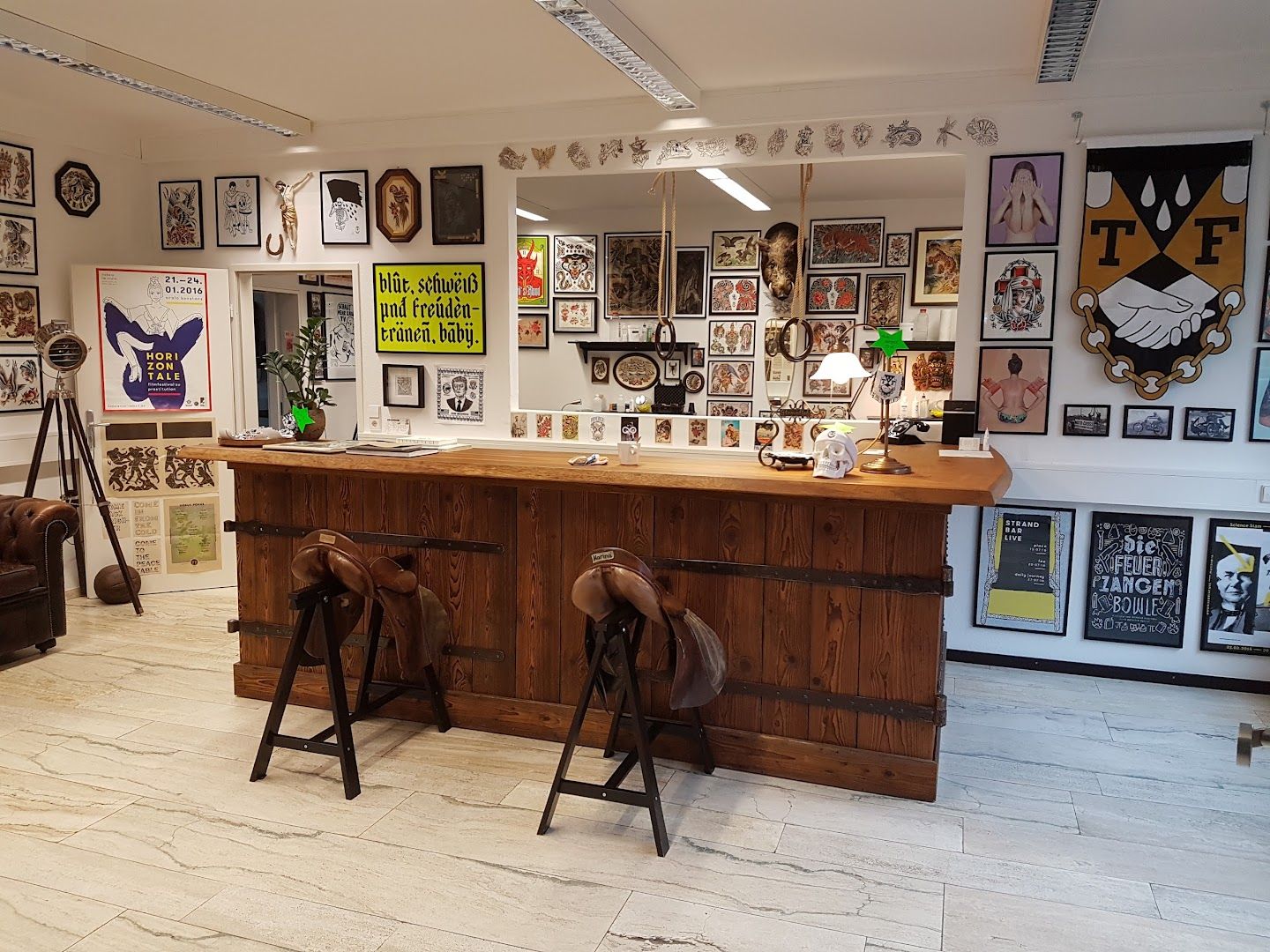 a room with a bar and a lot of pictures