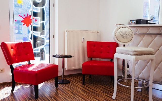 a room with a red chair and a mirror