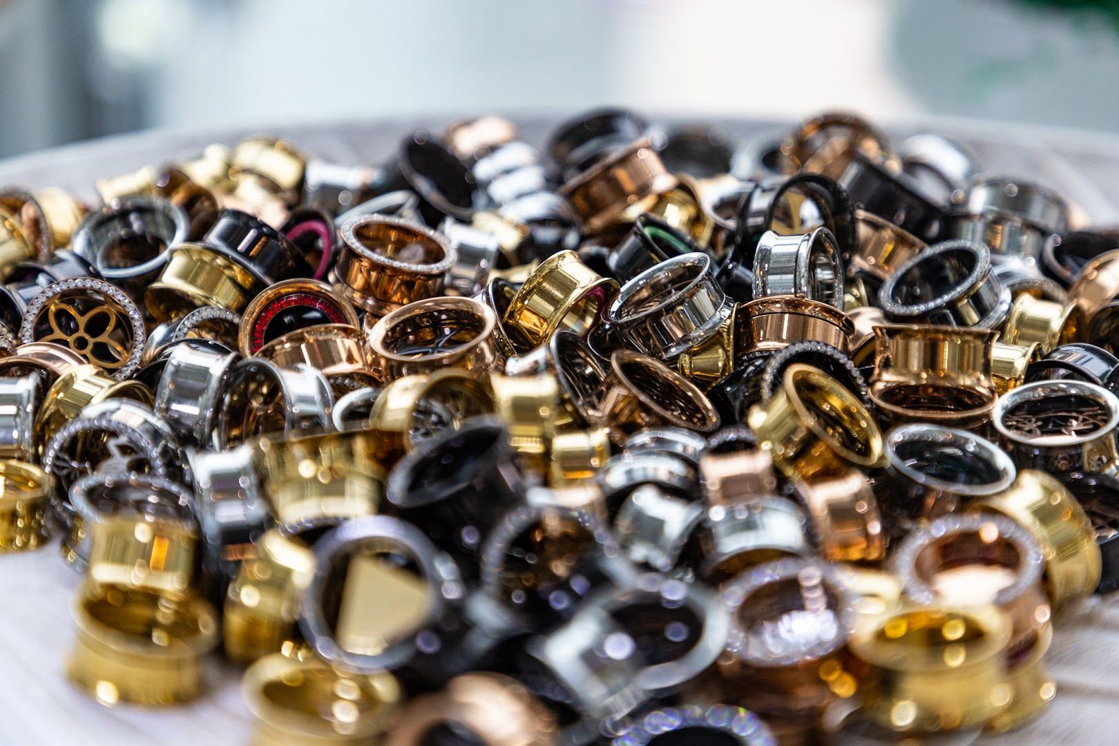 a plate full of gold and silver rings