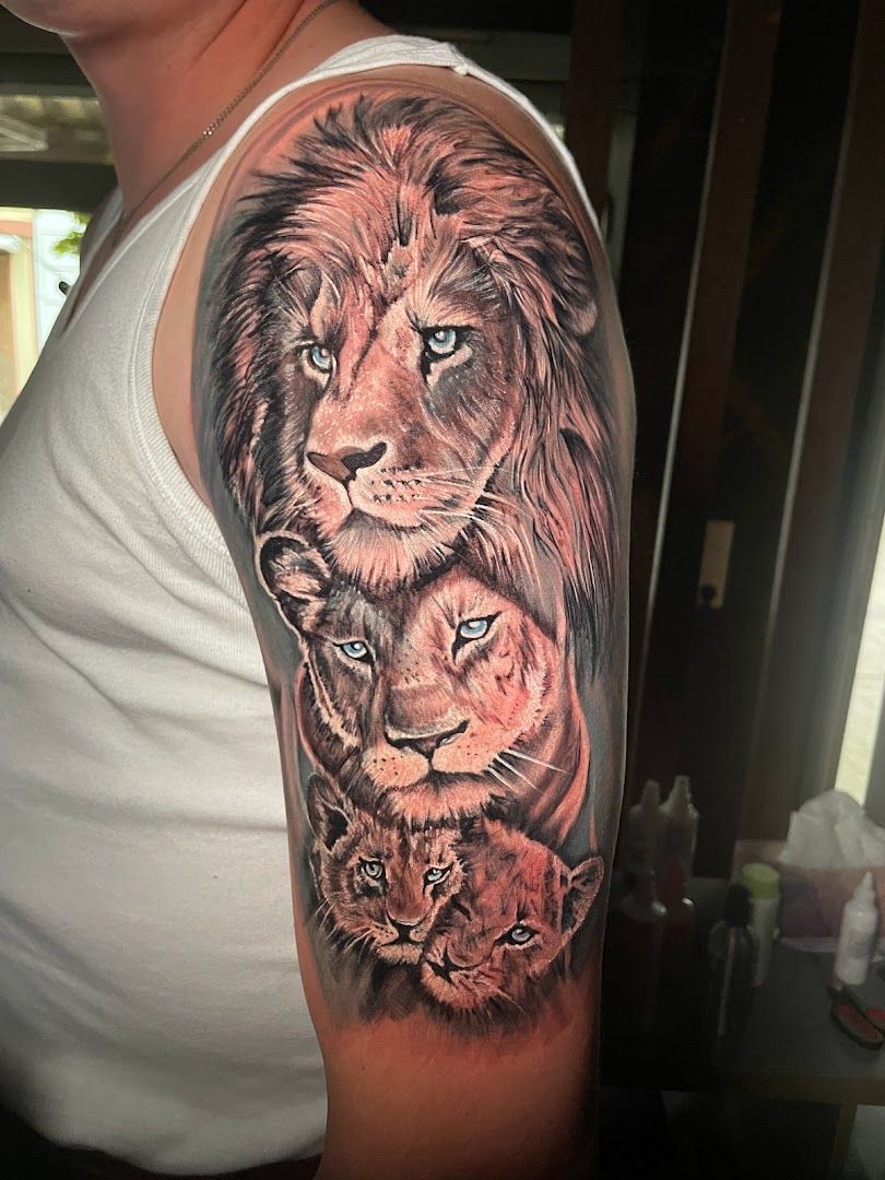 a lion and cub narben tattoo on the arm, cuxhaven, germany