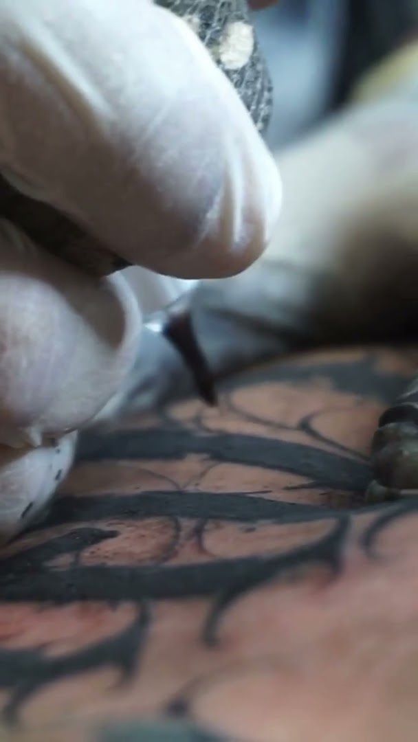 a person is working on a cover-up tattoo, düsseldorf, germany