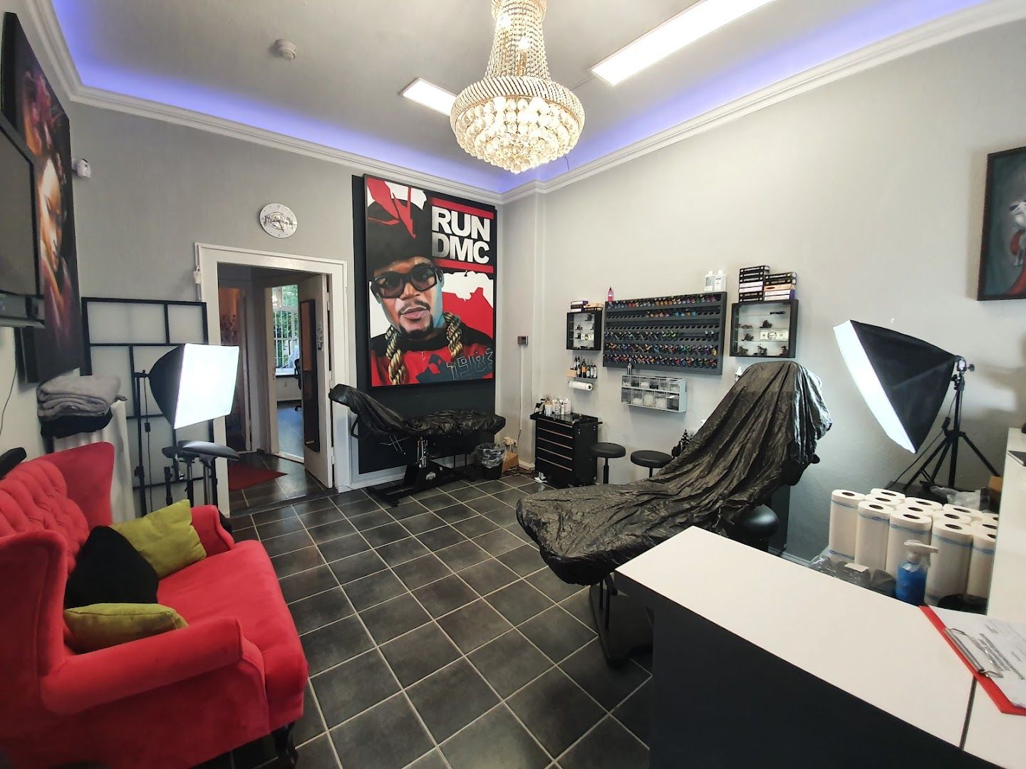 a room with a red chair and a black and white wall