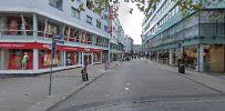 a street with buildings and people walking down it