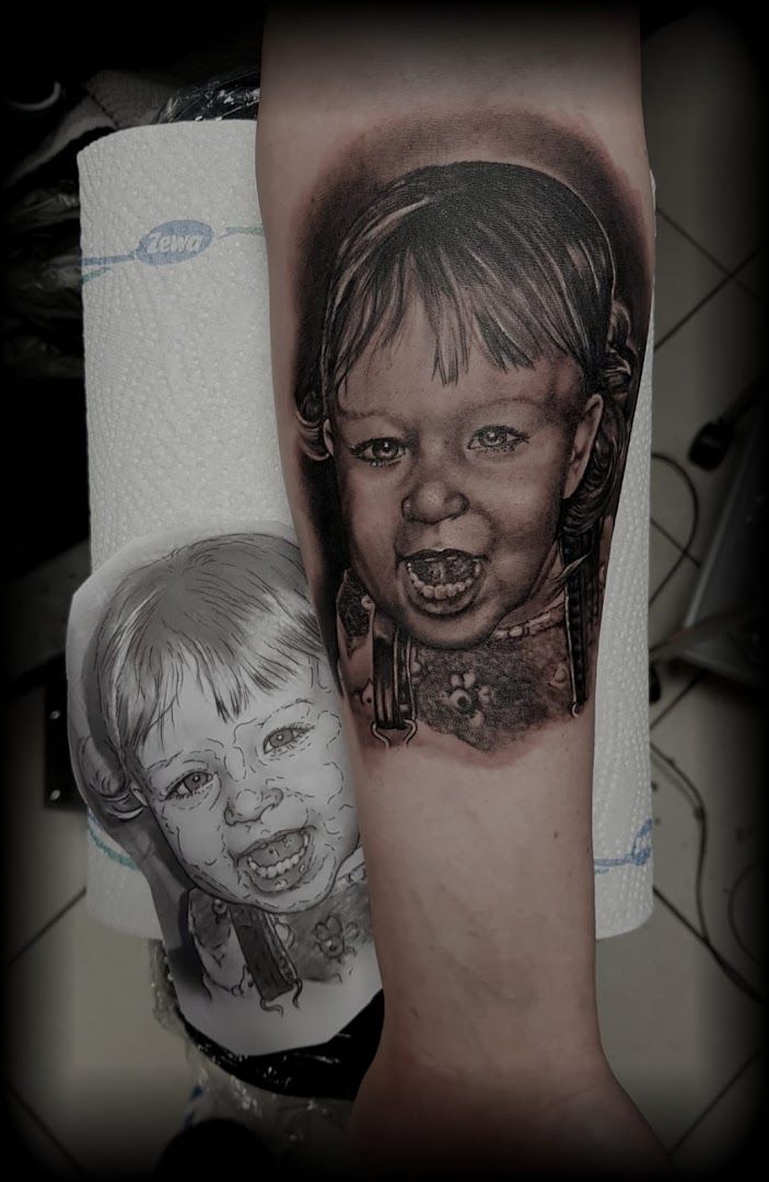 a cover-up tattoo of a child with a face and a woman's face, chemnitz, germany