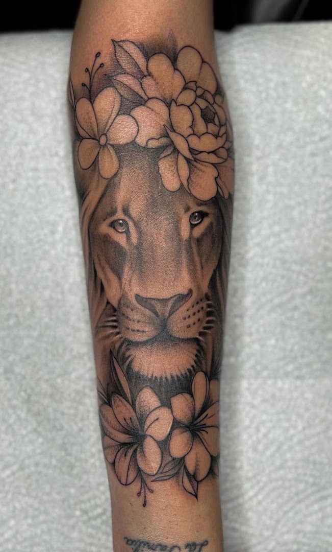 a lion with flowers on his arm