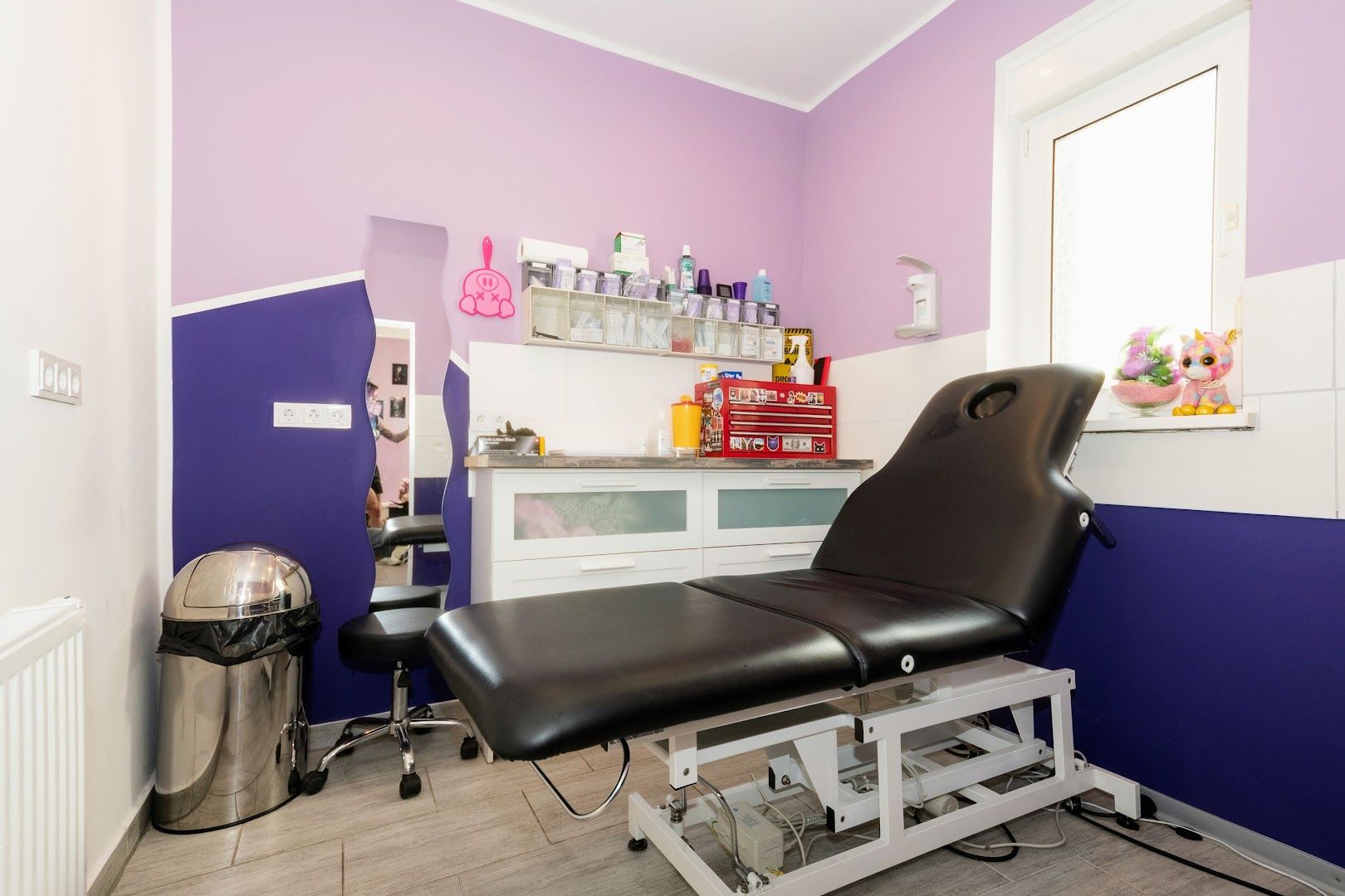 a salon room with a chair and a mirror