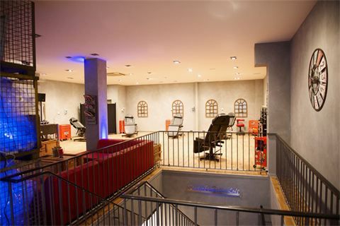 a room with a staircase and a red couch