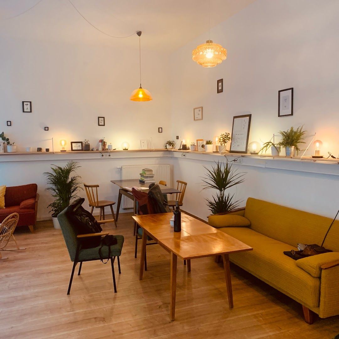 a living room with a couch, table and chairs