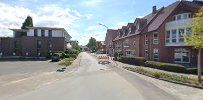 a street with houses and trees in the background