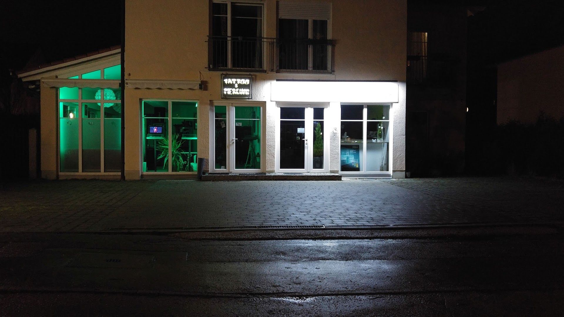 a building with a green light on the front