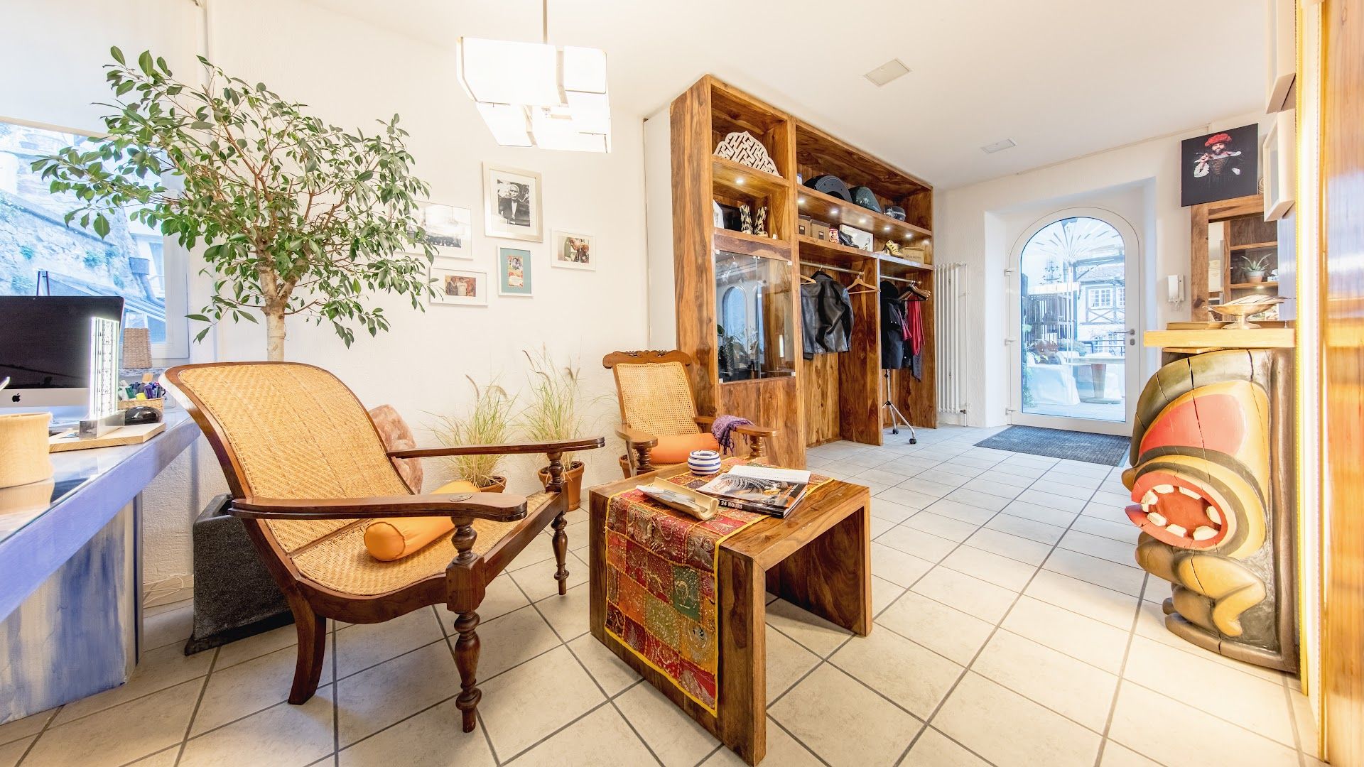 a living room with a chair and a plant