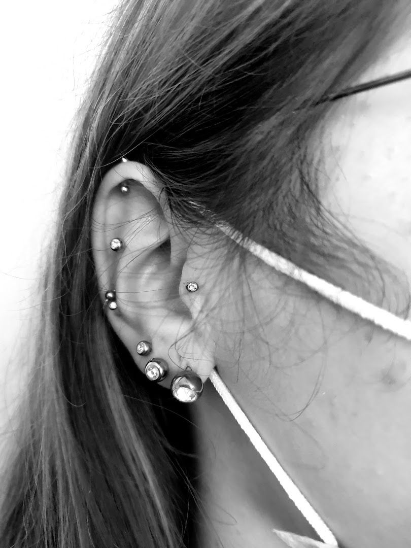 a woman wearing a pair of ear piercings