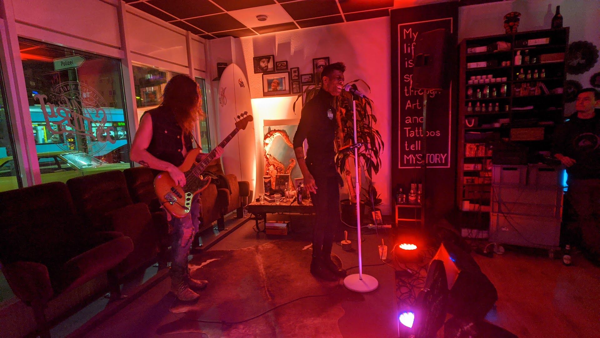 a man and a woman playing guitar in a room