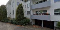 a white building with a garage and a driveway