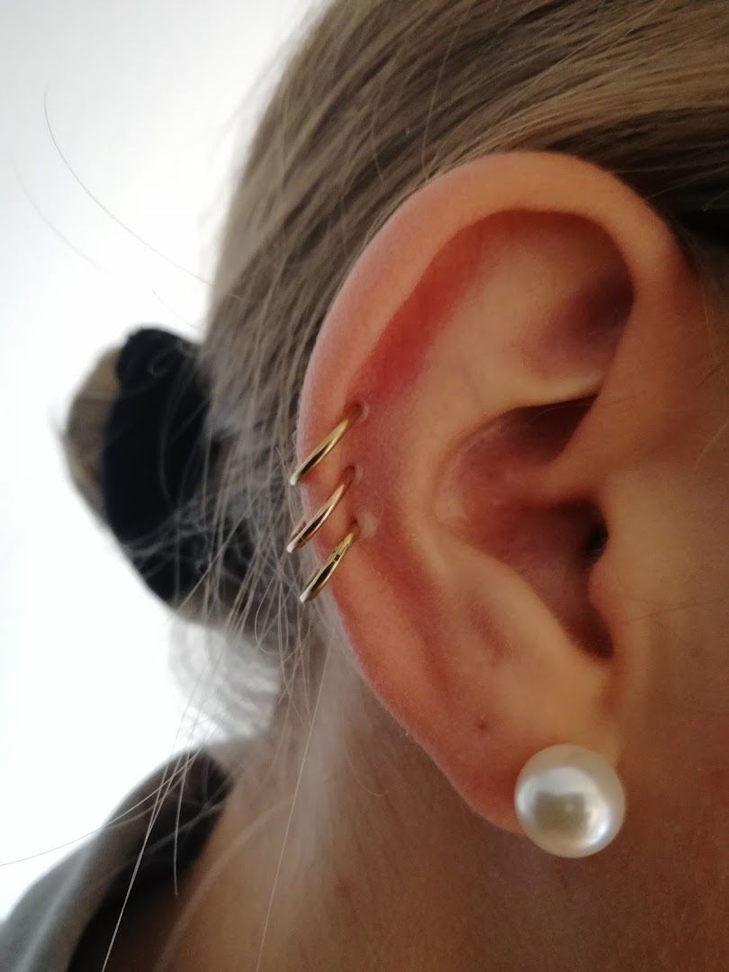 a woman with a pearl ear piercing