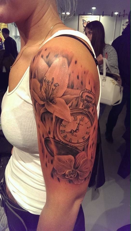 a woman with a clock cover-up tattoo on her arm, wesel, germany