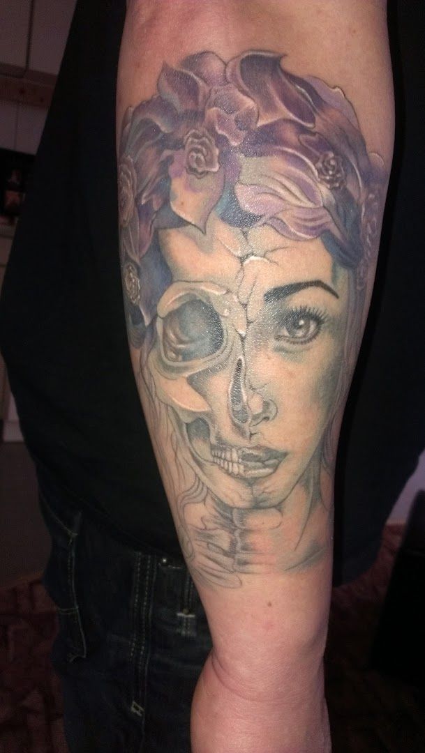 a woman with a skull cover-up tattoo on her arm, mittelsachsen, germany