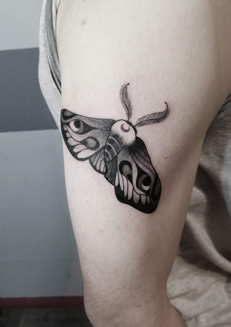 a black and white moth narben tattoo on the right arm, berlin, germany