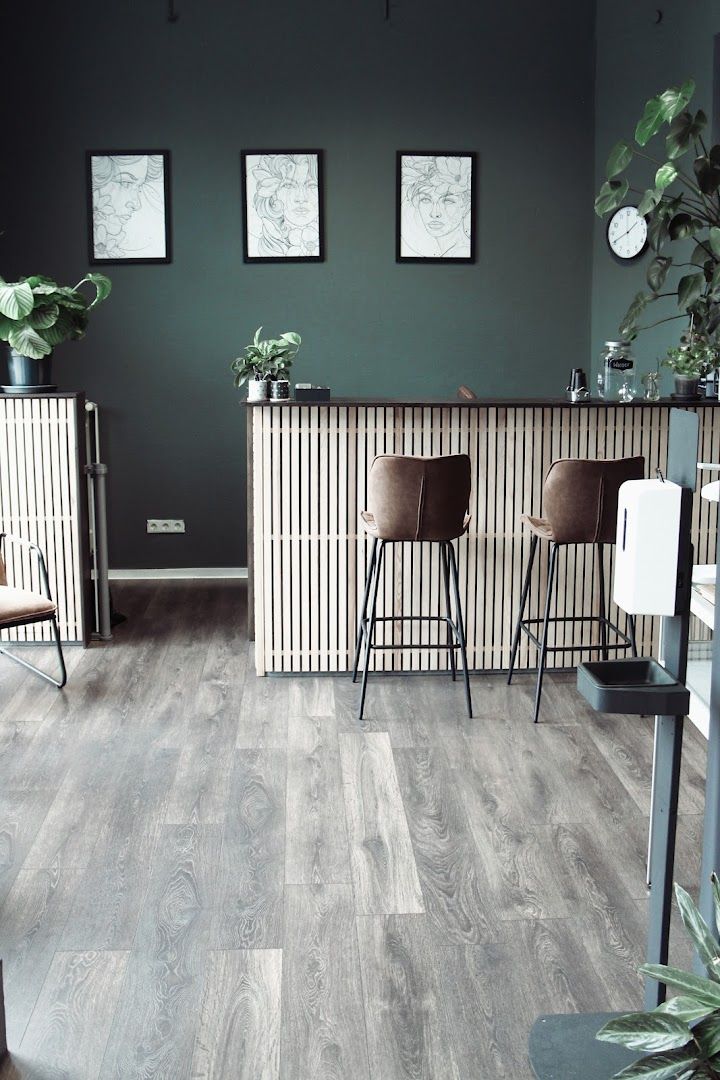 a dark green wall and a wooden floor with a grey wall