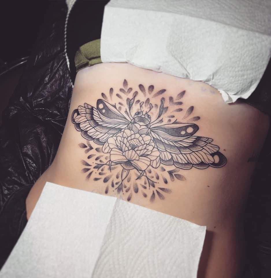 a narben tattoo design on the back of a woman, saale-orla-kreis, germany