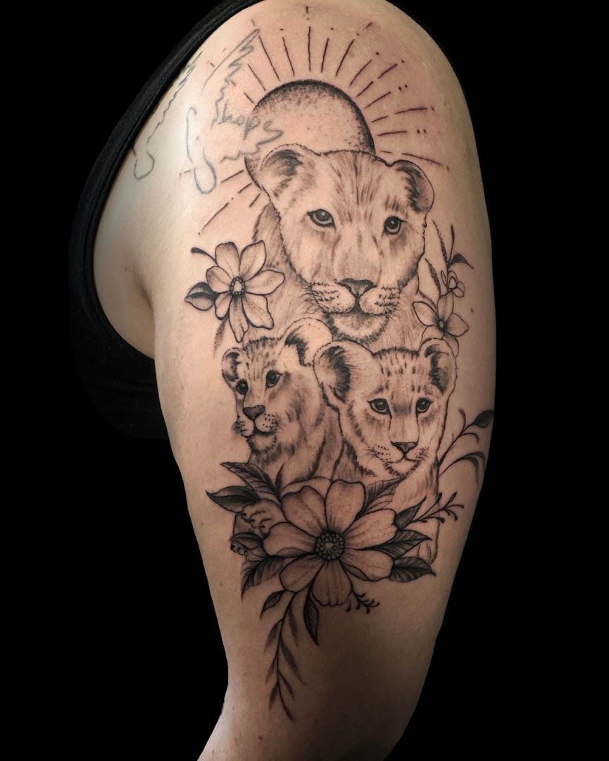 a lion and a lion cub cover-up tattoo by person, karlsruhe, germany