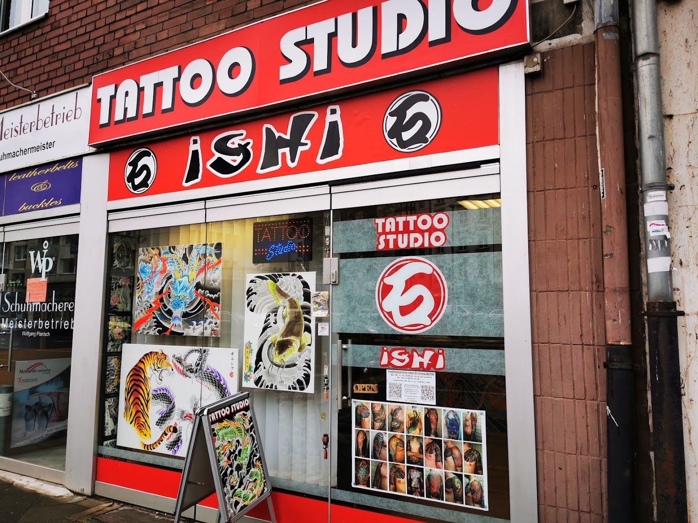 a store front with a red and white sign