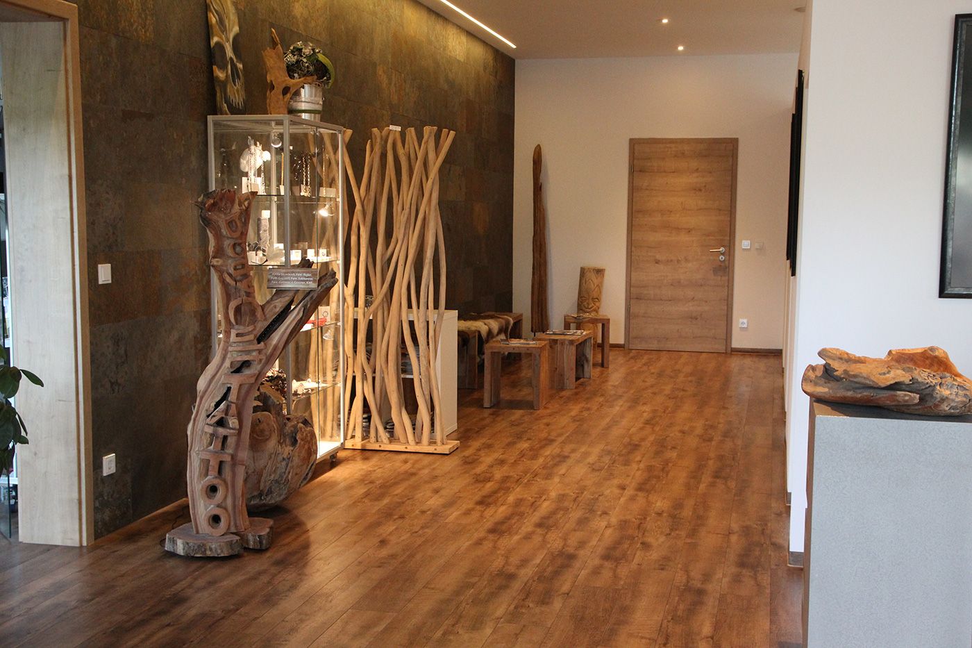 a room with a wooden floor and a large mirror