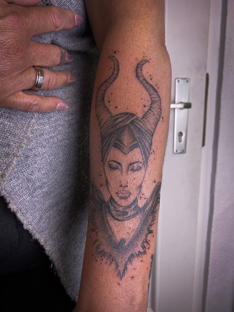 a woman's arm with a narben tattoo of a woman's face, schwalm-eder-kreis, germany