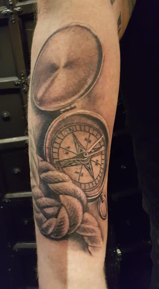 a cover-up tattoo of a hand holding a compass, mönchengladbach, germany