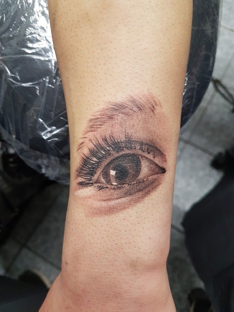 a cover-up tattoo of an eye with a small eye on the wrist, odenwaldkreis, germany