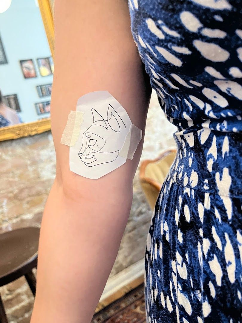 a woman with a trashpolka tattoos on her arm, berlin, germany