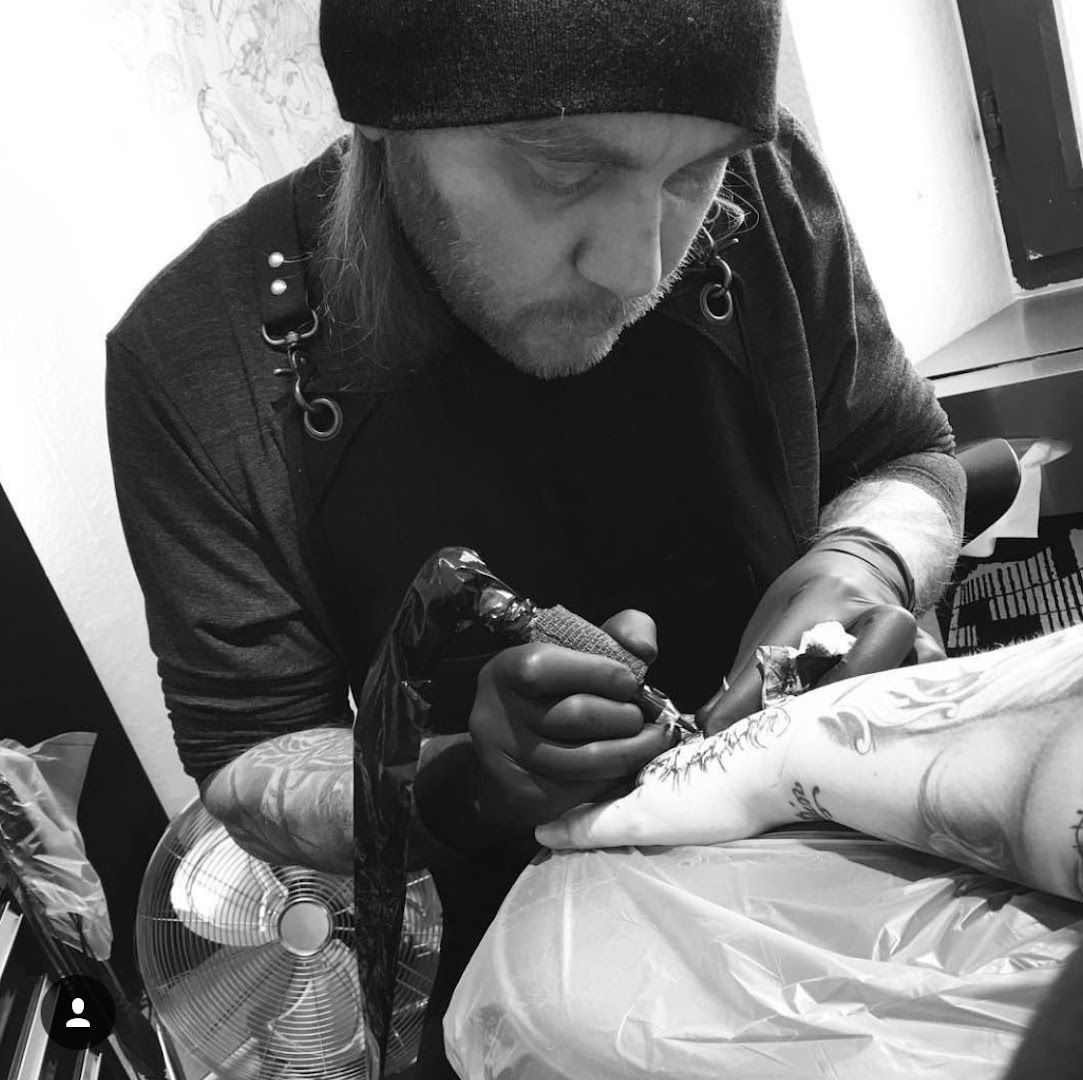 a man getting his cover-up tattoo done by a tattoo artist, kreisfreie stadt heilbronn, germany