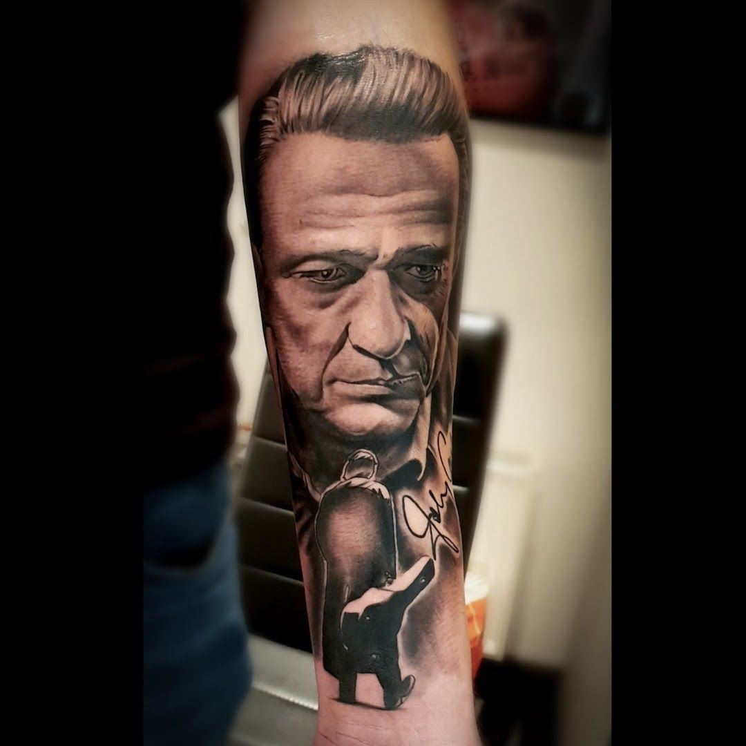 a man with a gun cover-up tattoo on his arm, mettmann, germany
