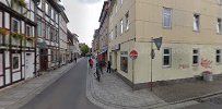 a street with buildings and a person walking down it