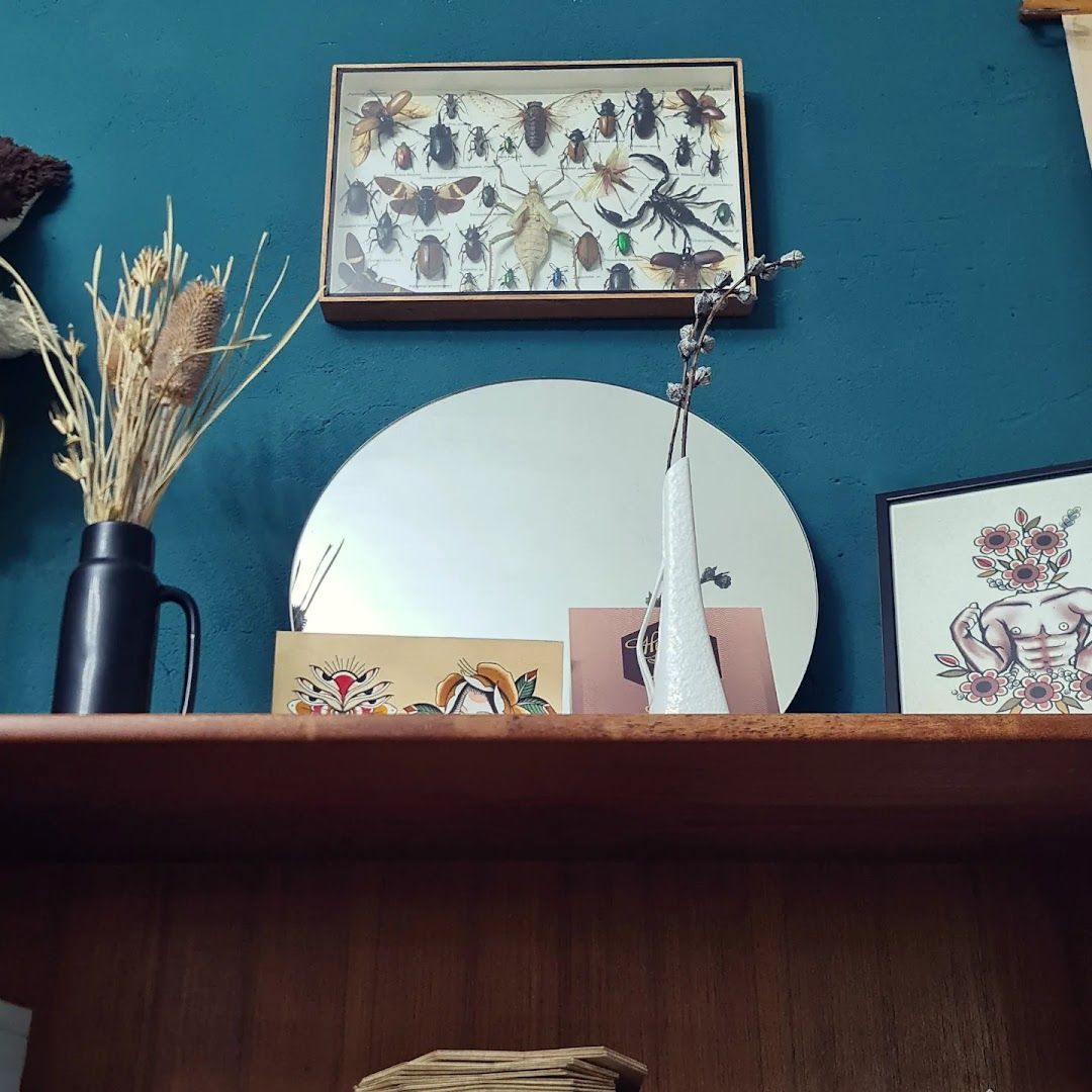 a shelf with a mirror, vase and other items