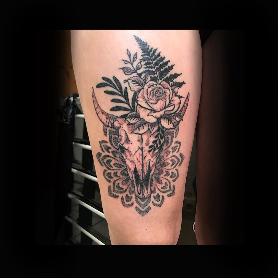 a black and white narben tattoo with a cow skull and flowers, schleswig-flensburg, germany