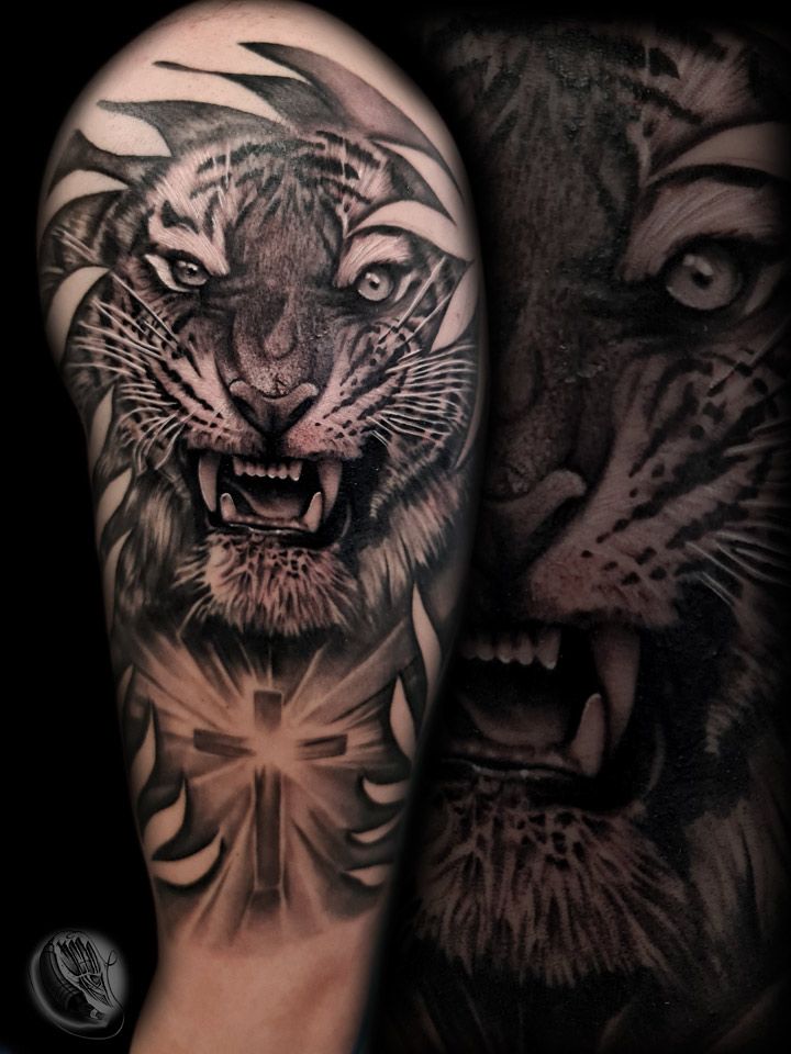 a black and grey cover-up tattoo of a tiger and a lion, berlin, germany