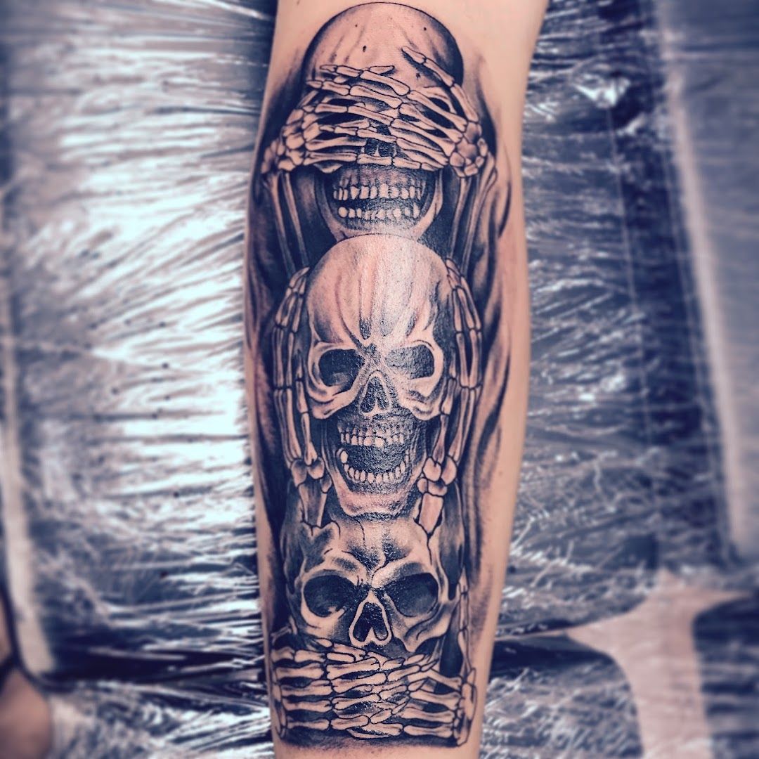 a skull and a skull head cover-up tattoo on the arm, schwarzwald-baar, germany