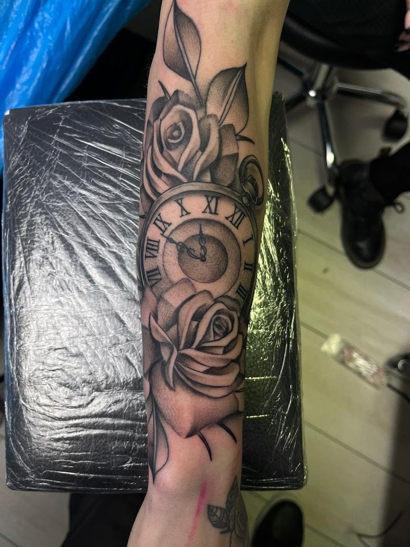 a cover-up tattoo with a clock and roses on the arm, märkisch-oderland, germany