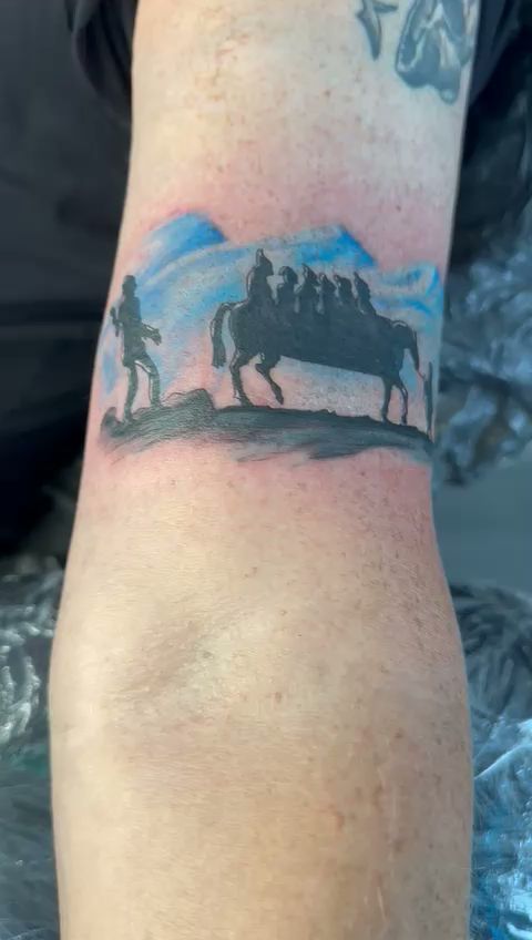 a cover-up tattoo of a horse and rider on the arm, dachau, germany