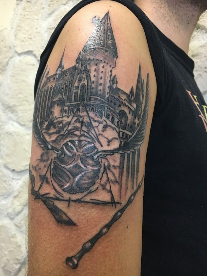 a cover-up tattoo of a castle with a sword and a skull, ahrweiler, germany