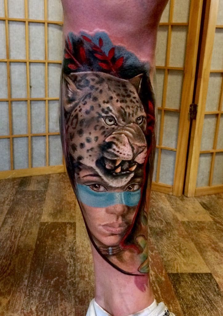 a cover-up tattoo of a leopard with a flower on his leg, görlitz, germany