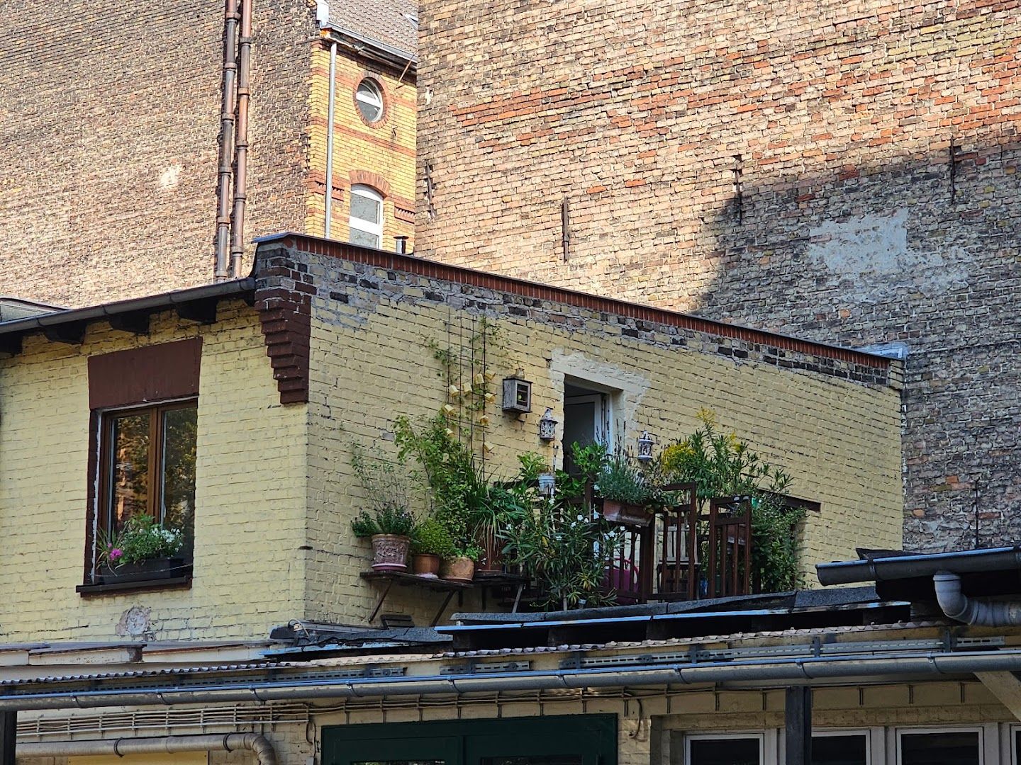 a building with a balcony and a clock on the top