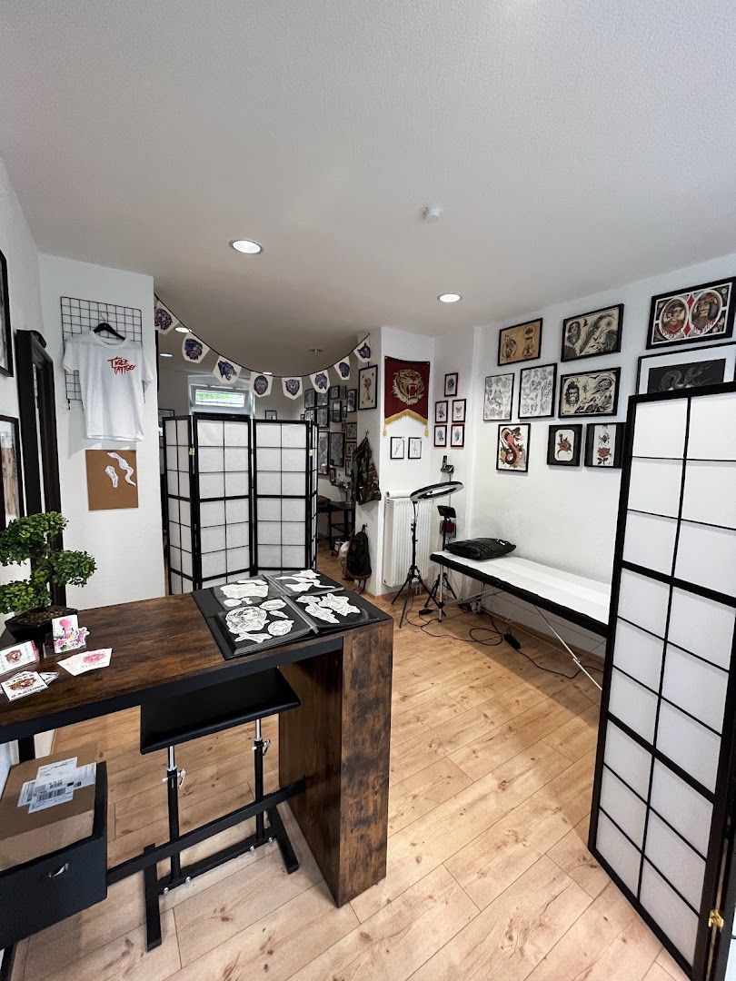 a room with a desk, chair and pictures on the wall