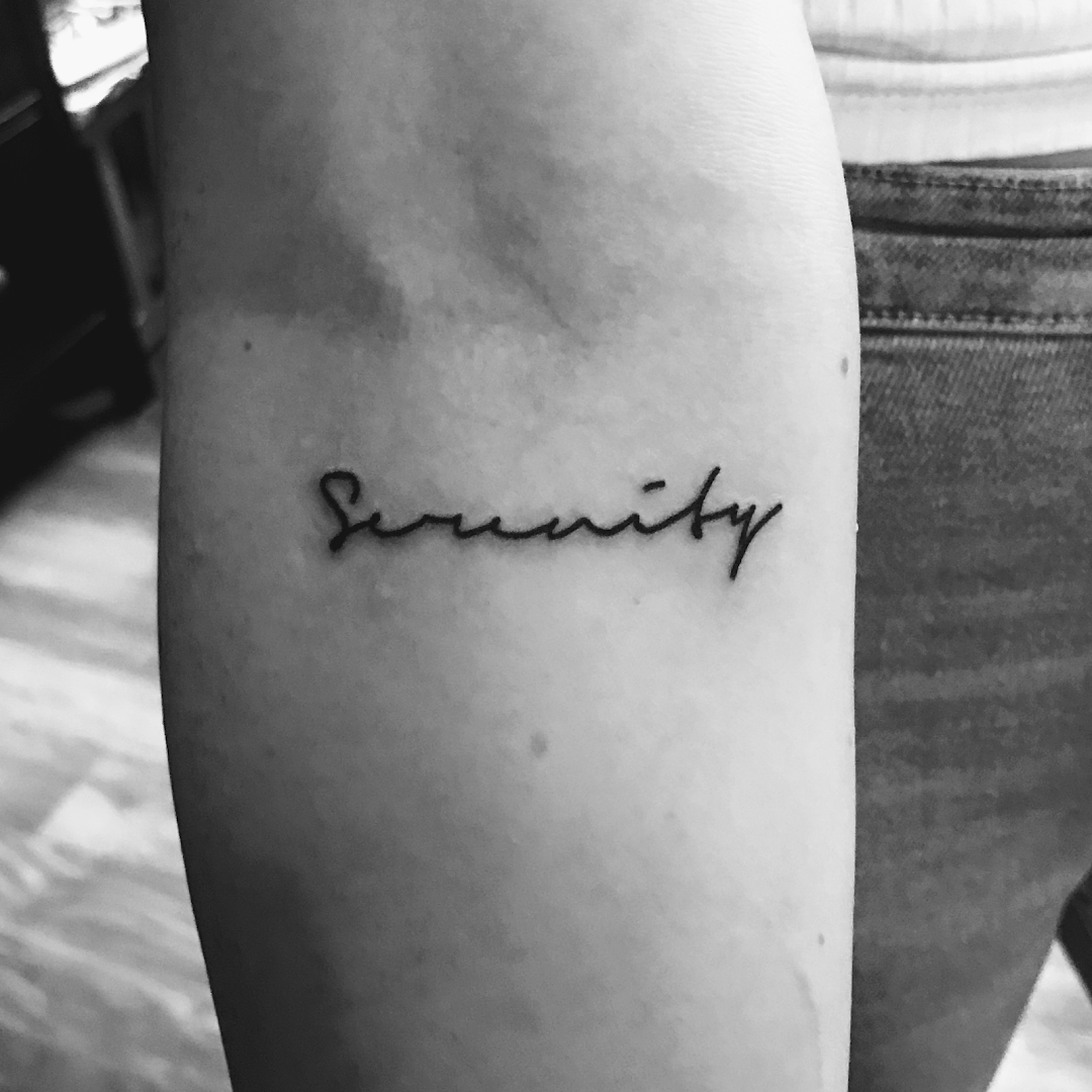 a woman's arm with a narben tattoo saying beauty, dresden, germany