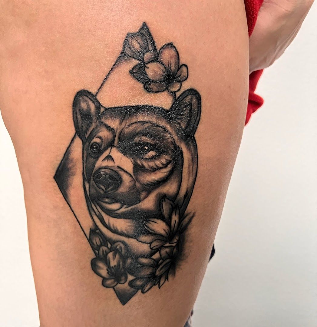 a black and white narben tattoo of a bear with a butterfly on its head, mittelsachsen, germany