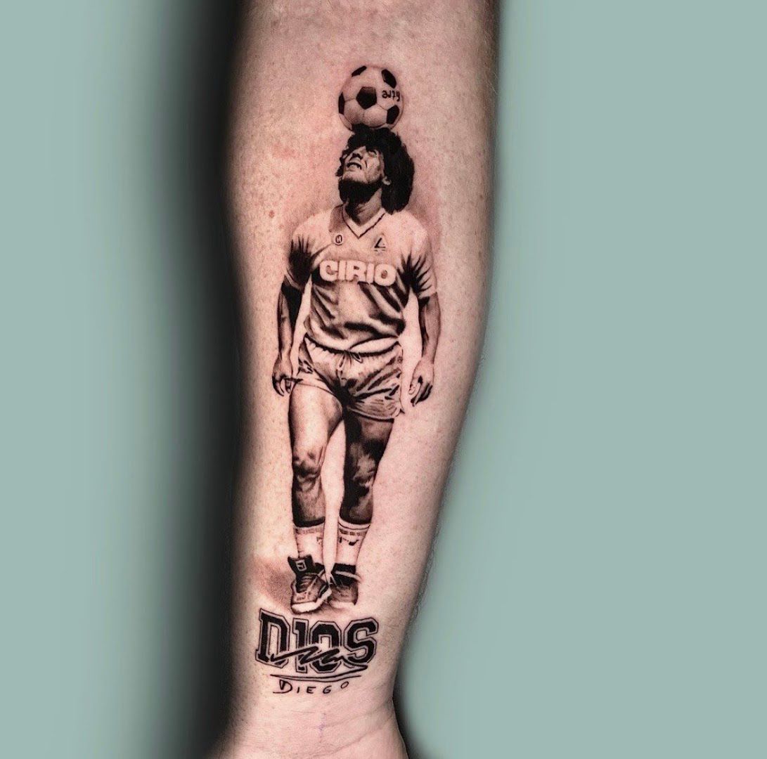 a cover-up tattoo of a soccer player with a ball on his leg, neunkirchen, germany